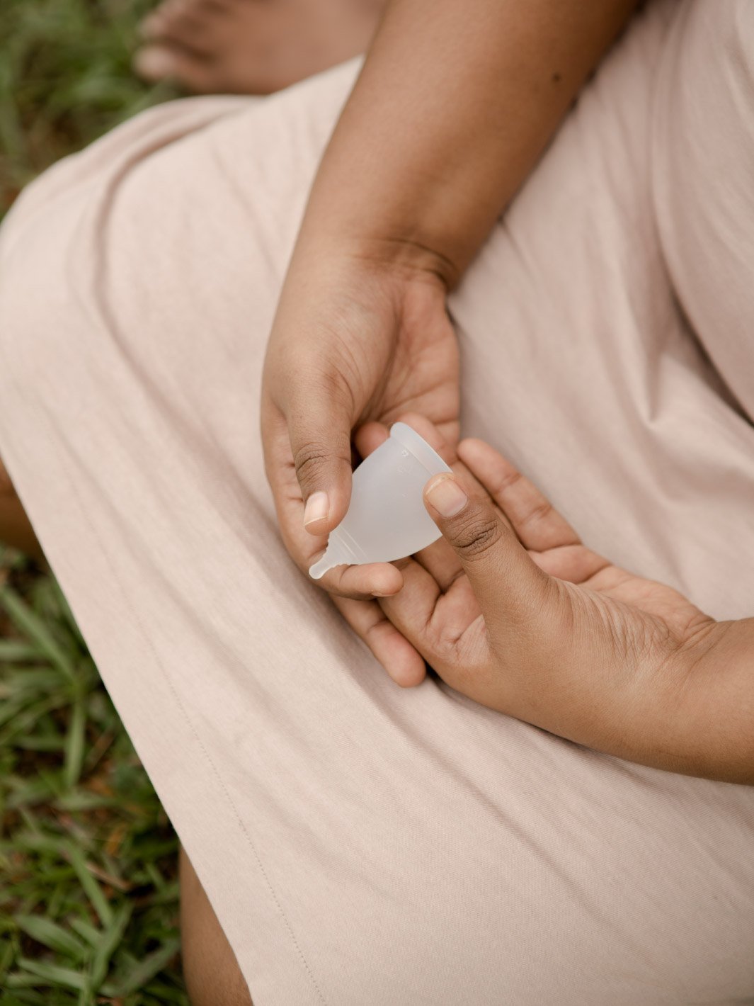 menstrual cup being held in a girl's hand